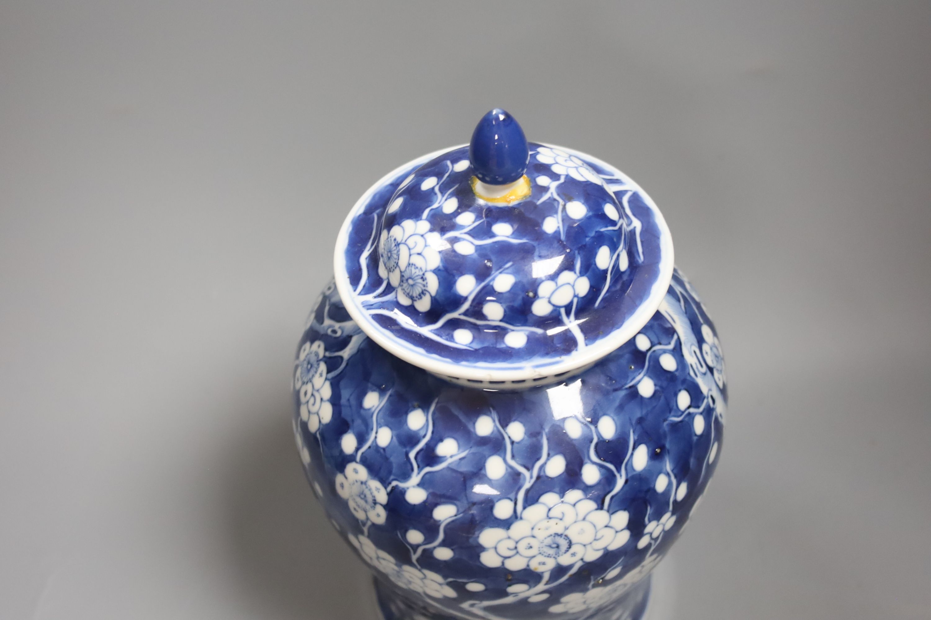 A 20th century Chinese blue and white jar and cover with prunus decoration, height 25cm